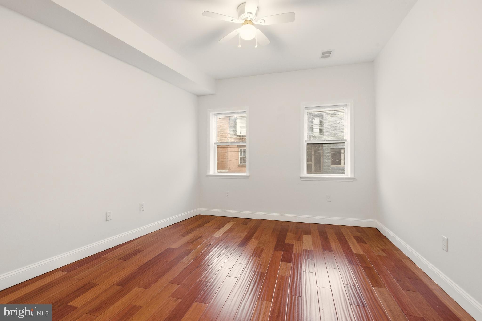 909 North 4th Street Philadelphia, PA 19123 - Photo 12 of 24 an empty room with wooden floor and windows