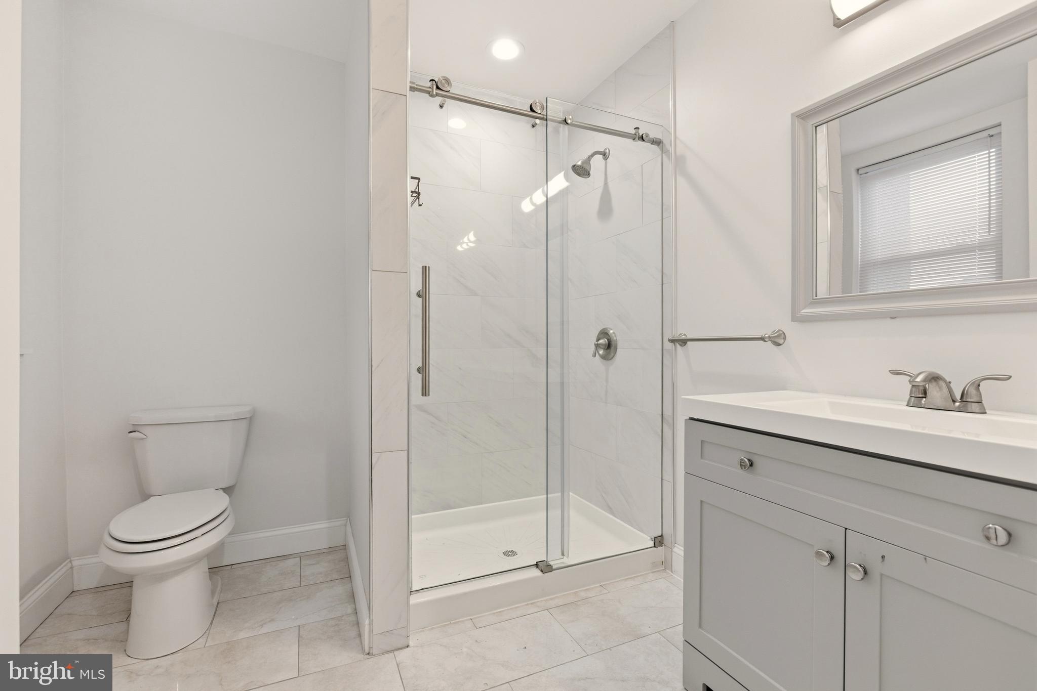909 North 4th Street Philadelphia, PA 19123 - Photo 18 of 24 a bathroom with a shower sink mirror and toilet