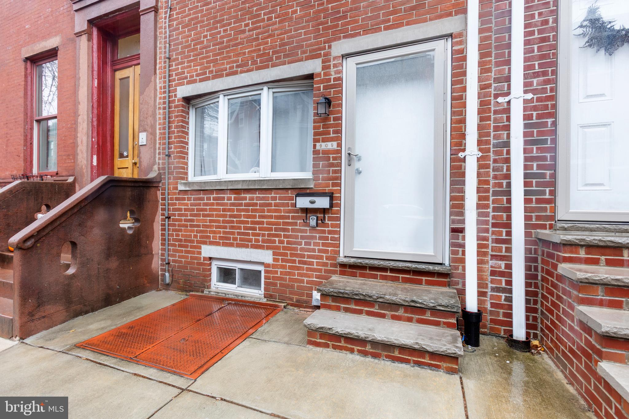 909 North 4th Street Philadelphia, PA 19123 - Photo 2 of 24 a backyard of a house with barbeque oven and wooden fence
