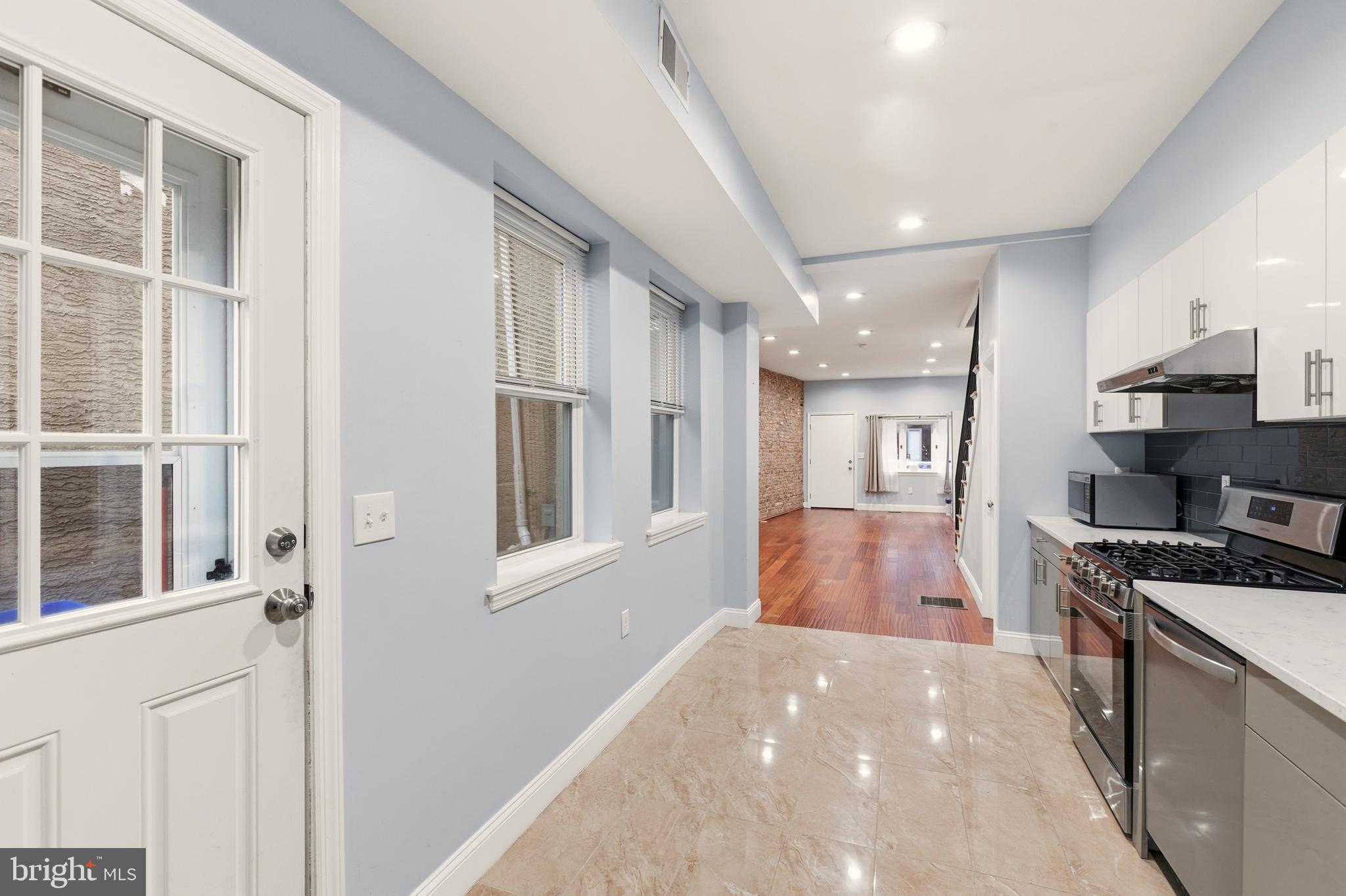 909 North 4th Street Philadelphia, PA 19123 - Photo 7 of 24 a kitchen with stainless steel appliances granite countertop a refrigerator and a sink