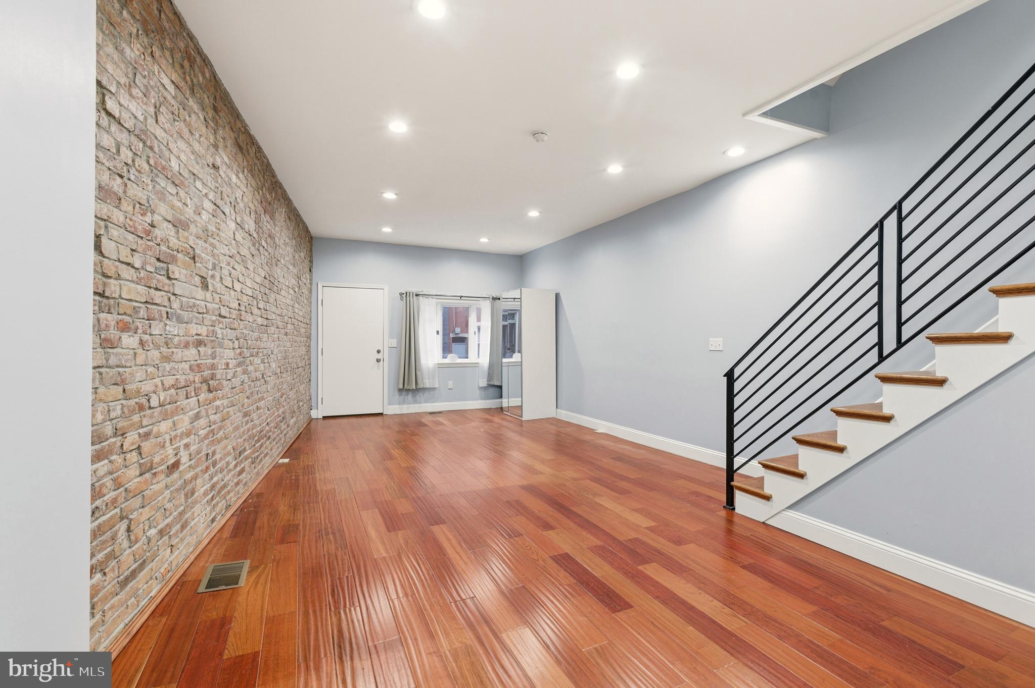 909 North 4th Street Philadelphia, PA 19123 - Photo 8 of 24 a view of an empty room and stairs with wooden floor