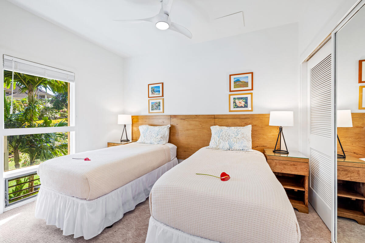 2371 Ho'ohu Road, Unit 703 Koloa, HI 96756 - Photo 12 of 27 a bedroom with two beds and a large window