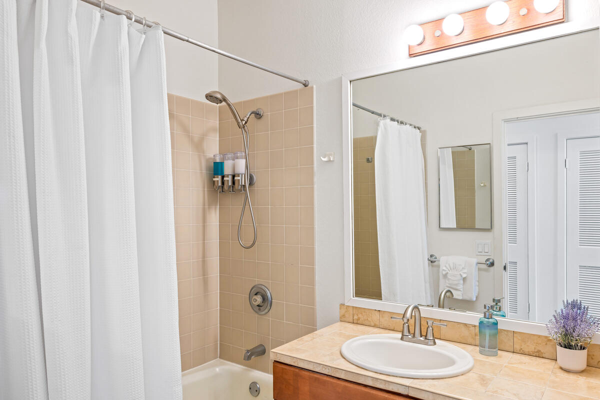 2371 Ho'ohu Road, Unit 703 Koloa, HI 96756 - Photo 14 of 27 a bathroom with a granite countertop sink toilet and shower