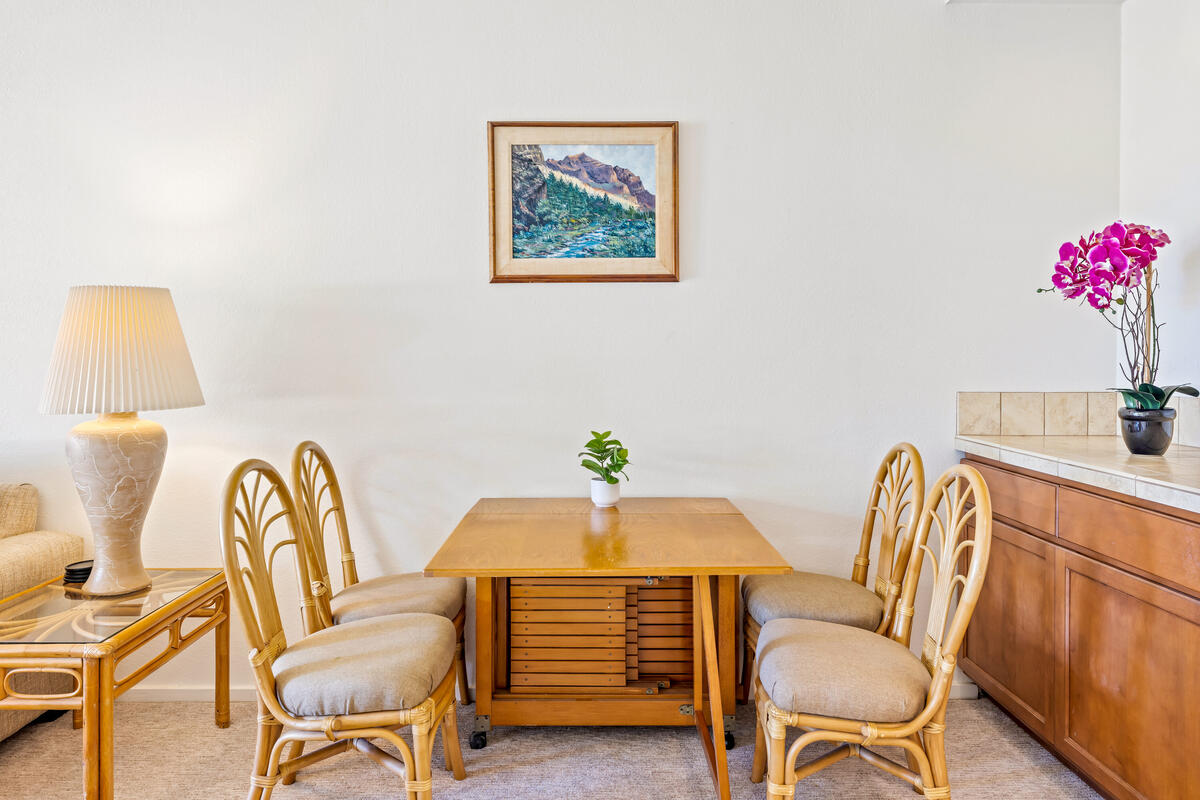 2371 Ho'ohu Road, Unit 703 Koloa, HI 96756 - Photo 7 of 27 a view of a dining room with furniture and wooden floor