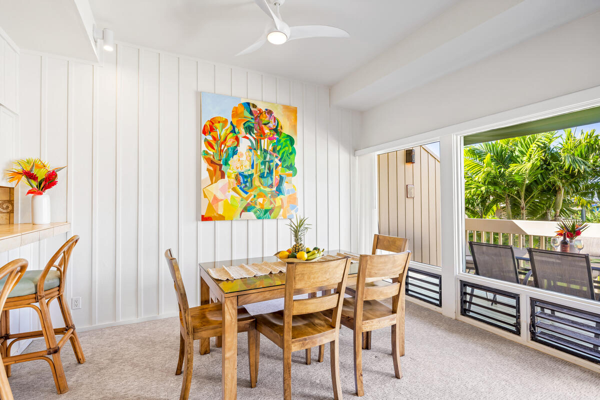 2371 Ho'ohu Road, Unit 703 Koloa, HI 96756 - Photo 10 of 27 a dining room with furniture and a floor to ceiling window