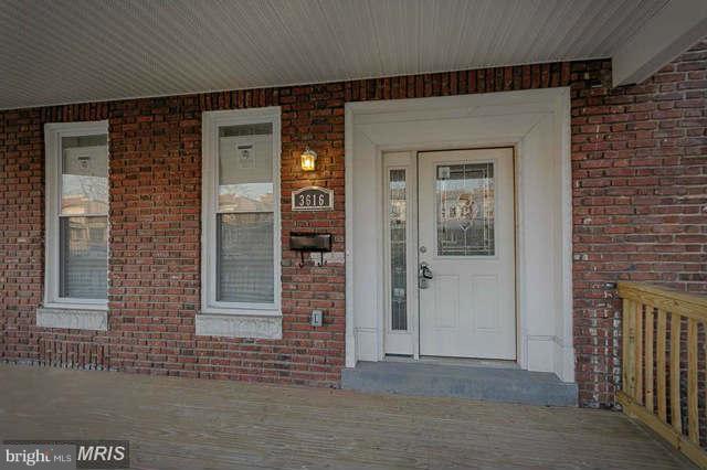 3616 Reisterstown Road Baltimore, MD 21215 - Photo 2 of 26 front view of a brick house with a door