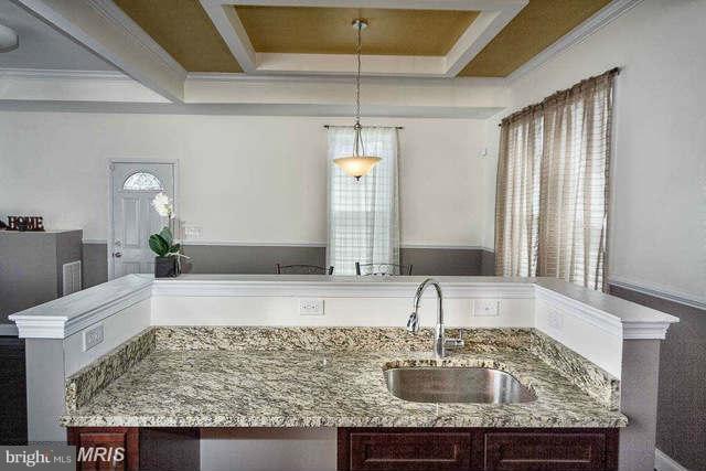 3616 Reisterstown Road Baltimore, MD 21215 - Photo 11 of 26 a bathroom with a granite countertop sink and a mirror