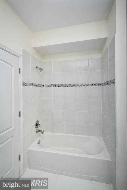 3616 Reisterstown Road Baltimore, MD 21215 - Photo 24 of 26 a bathroom with a shower and a bath tub
