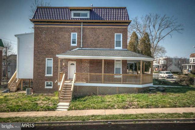 3616 Reisterstown Road Baltimore, MD 21215 - Photo 5 of 26 a front view of a house with a yard