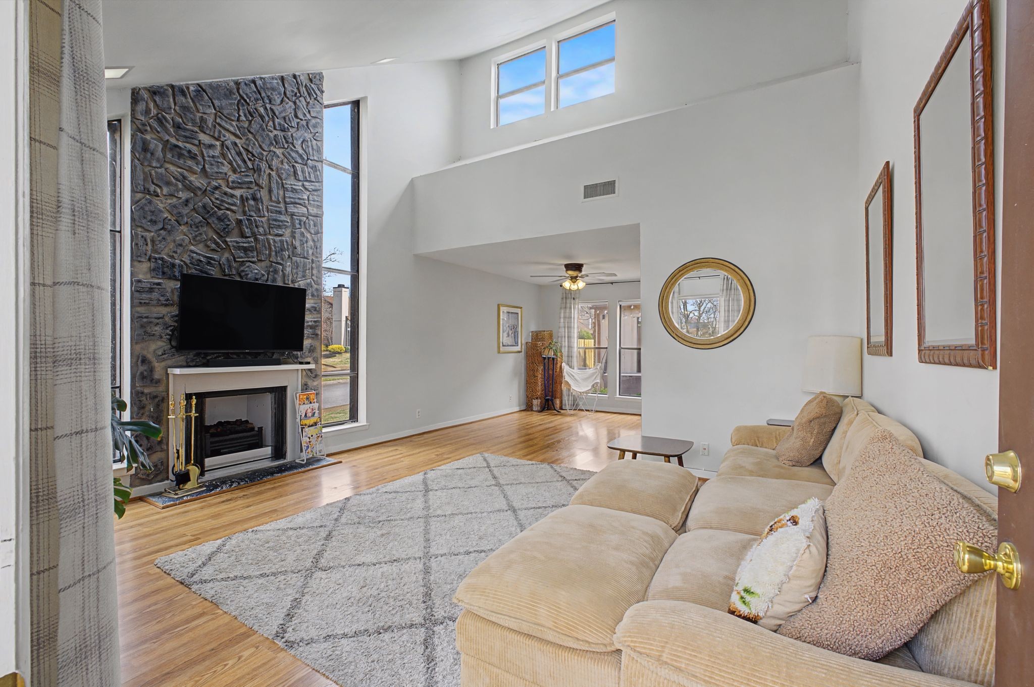 218 Harpers Mill Road Hermitage, TN 37076 - Photo 4 of 29 a living room with furniture a flat screen tv and a fireplace