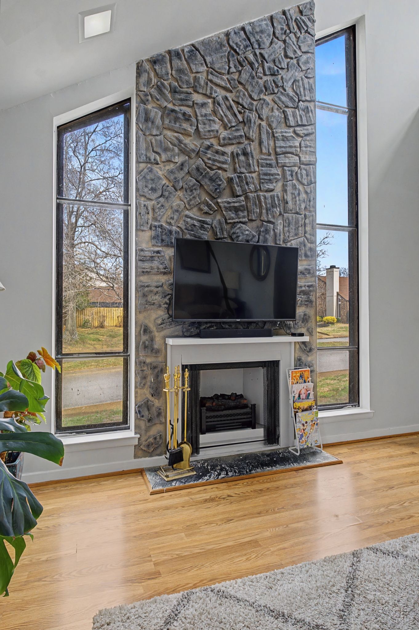 218 Harpers Mill Road Hermitage, TN 37076 - Photo 5 of 29 a living room with a fireplace and a wooden floor