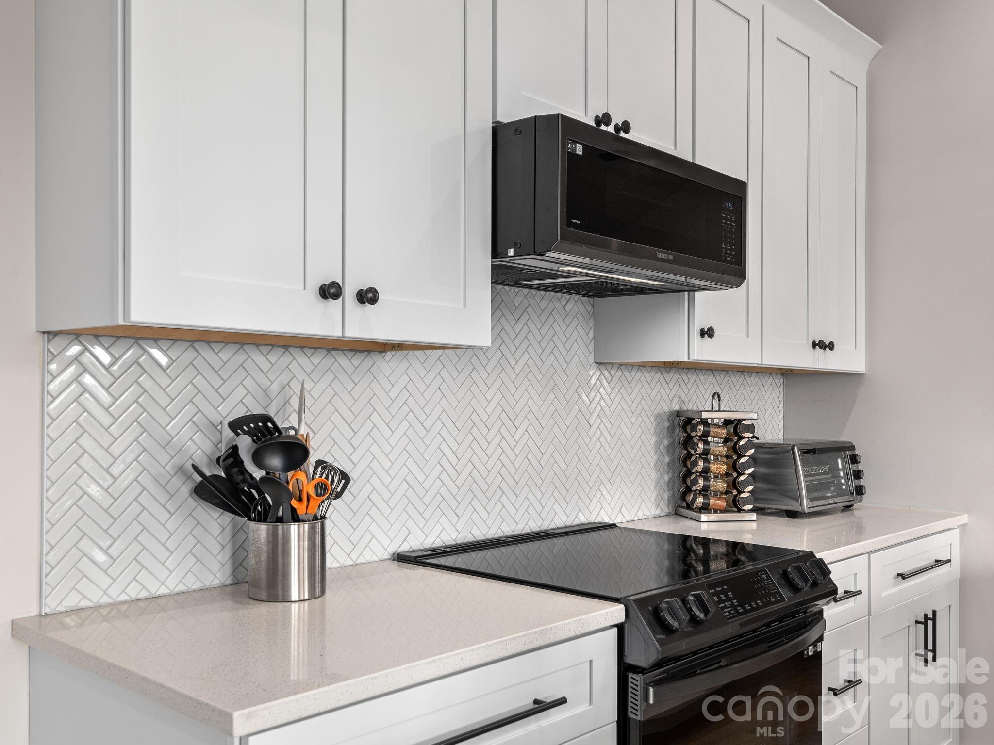 2201 Bulling Creek Road Hendersonville, NC 28739 - Photo 14 of 47 a kitchen with a stove and a microwave