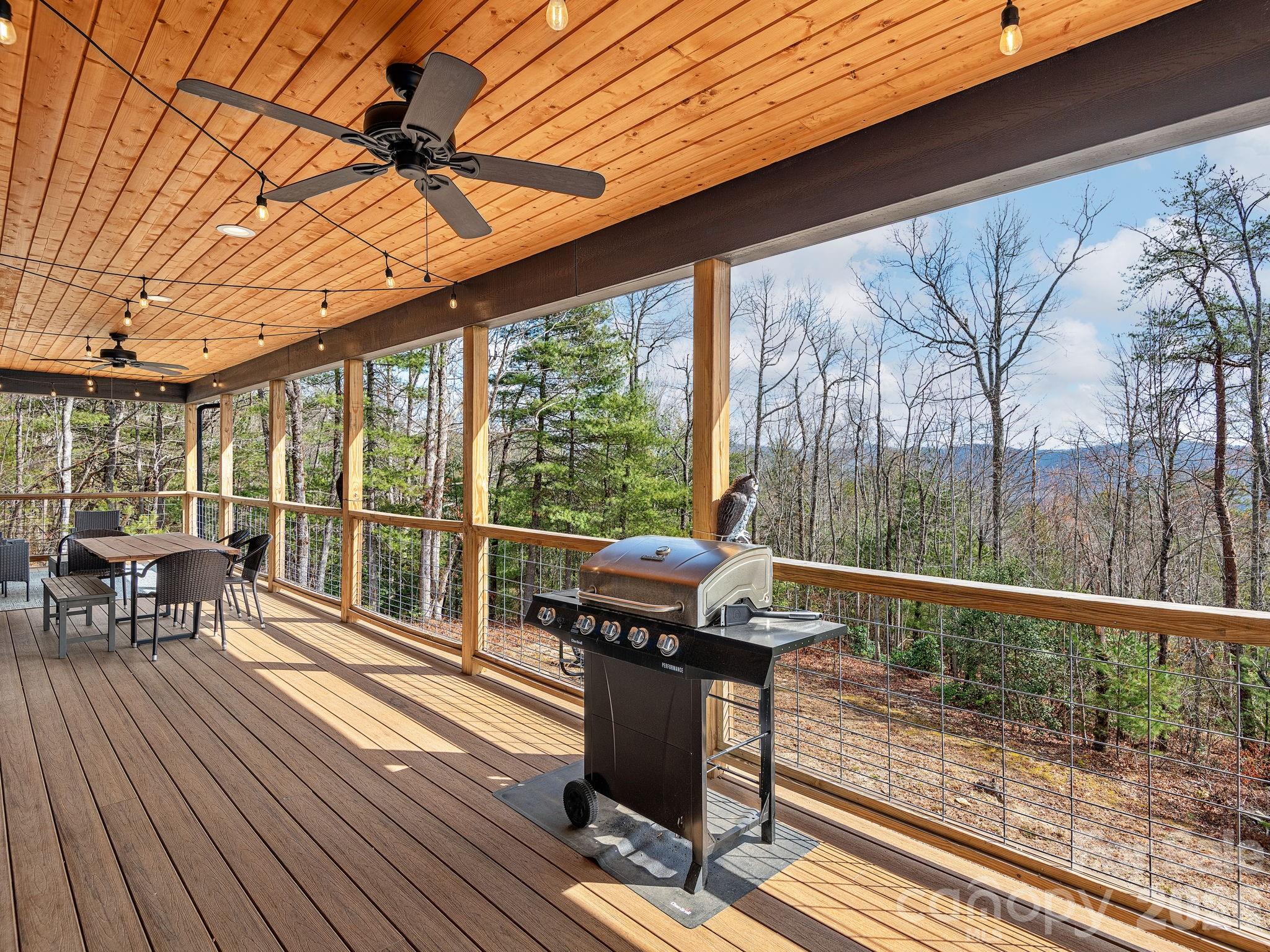 2201 Bulling Creek Road Hendersonville, NC 28739 - Photo 20 of 47 a view of a balcony with chairs and wooden floor