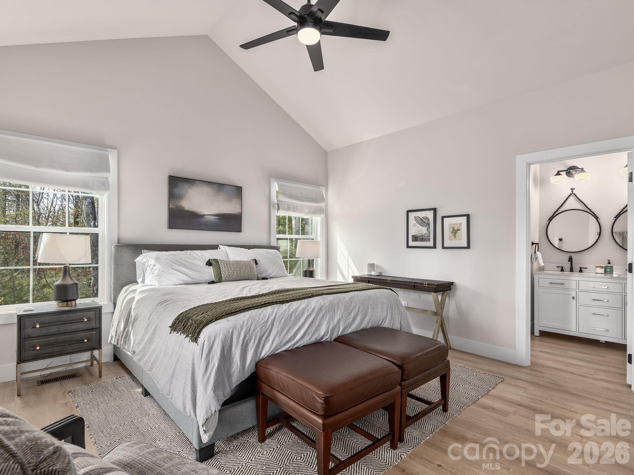 2201 Bulling Creek Road Hendersonville, NC 28739 - Photo 21 of 47 a bedroom with a bed a mirror on dresser and a window