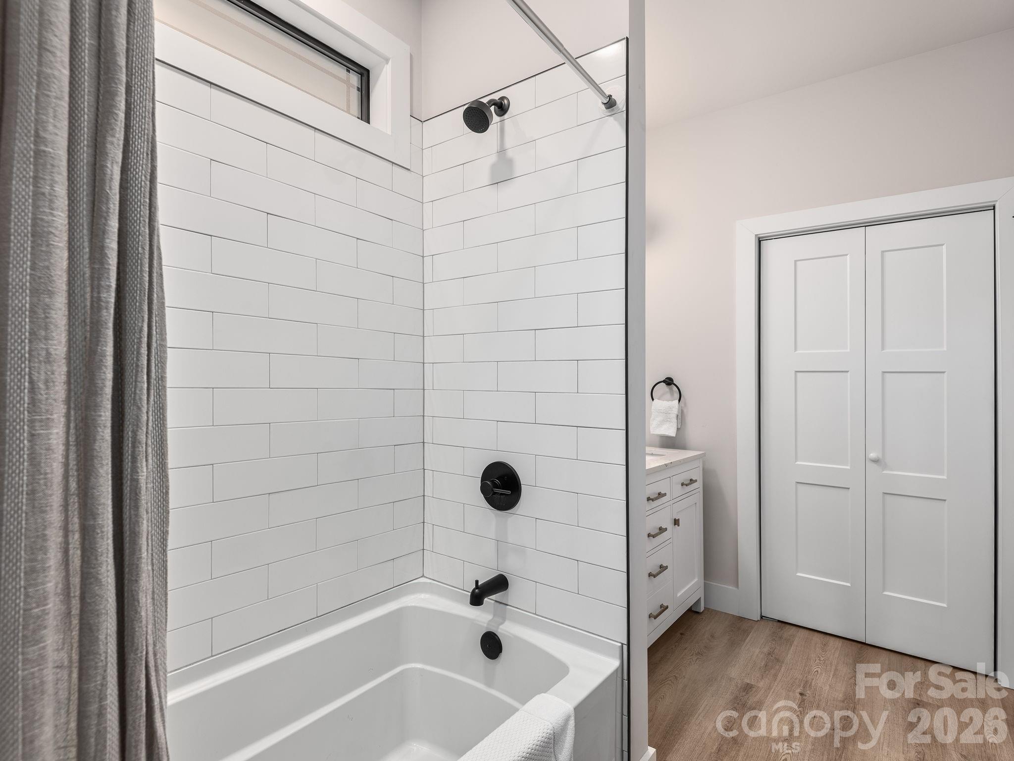 2201 Bulling Creek Road Hendersonville, NC 28739 - Photo 23 of 47 a bathroom with a tub shower and vanity