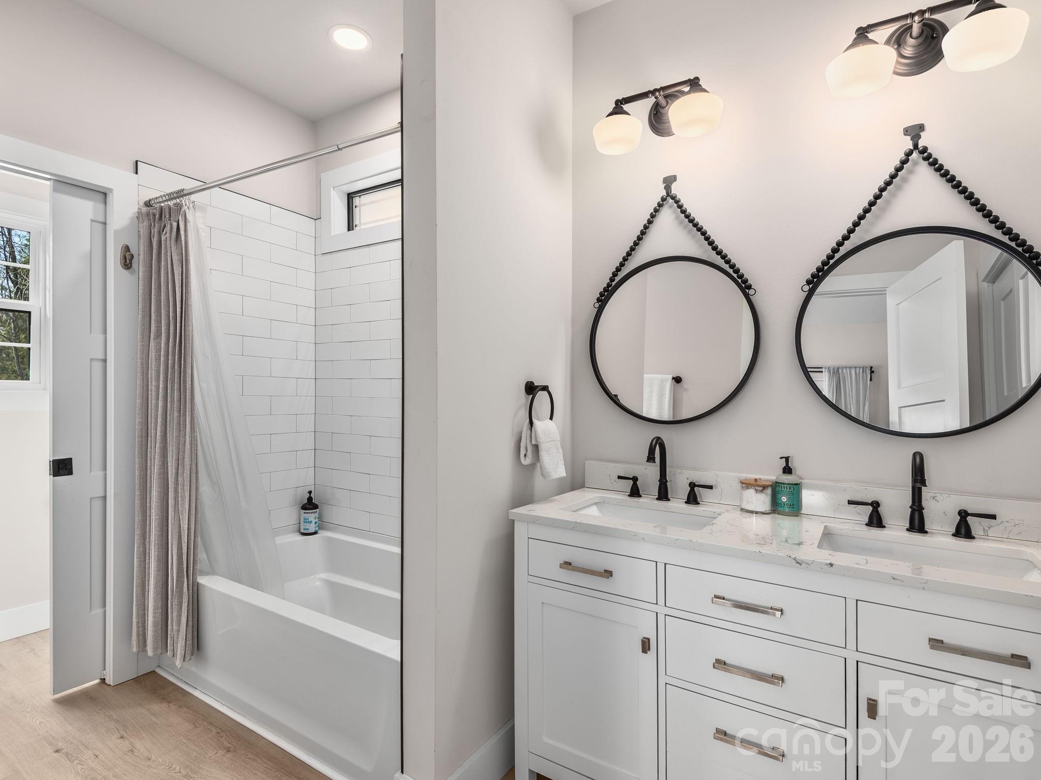2201 Bulling Creek Road Hendersonville, NC 28739 - Photo 24 of 47 a bathroom with a double vanity sink mirror bathtub and shower