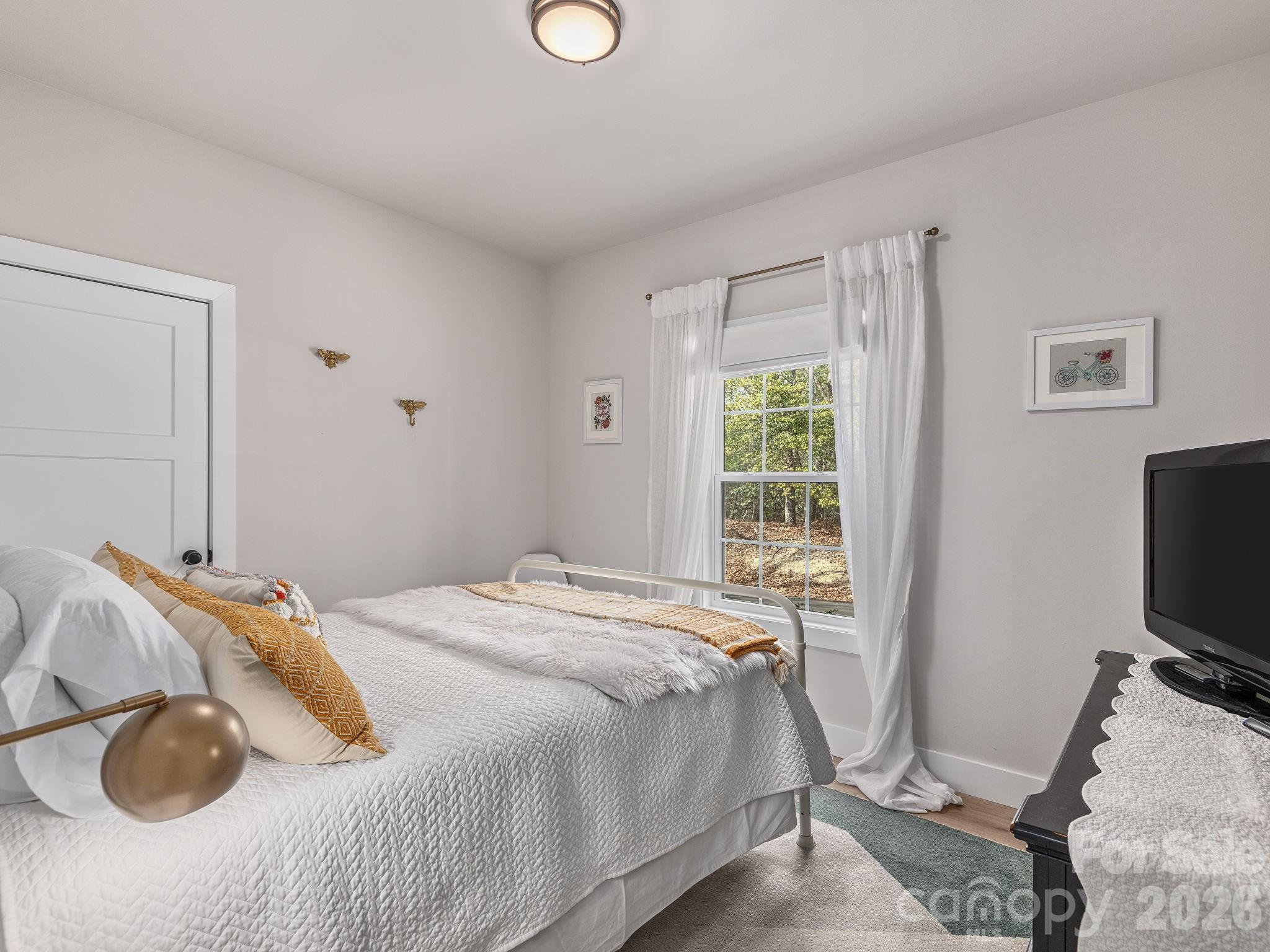 2201 Bulling Creek Road Hendersonville, NC 28739 - Photo 26 of 47 a bedroom with a bed and a window