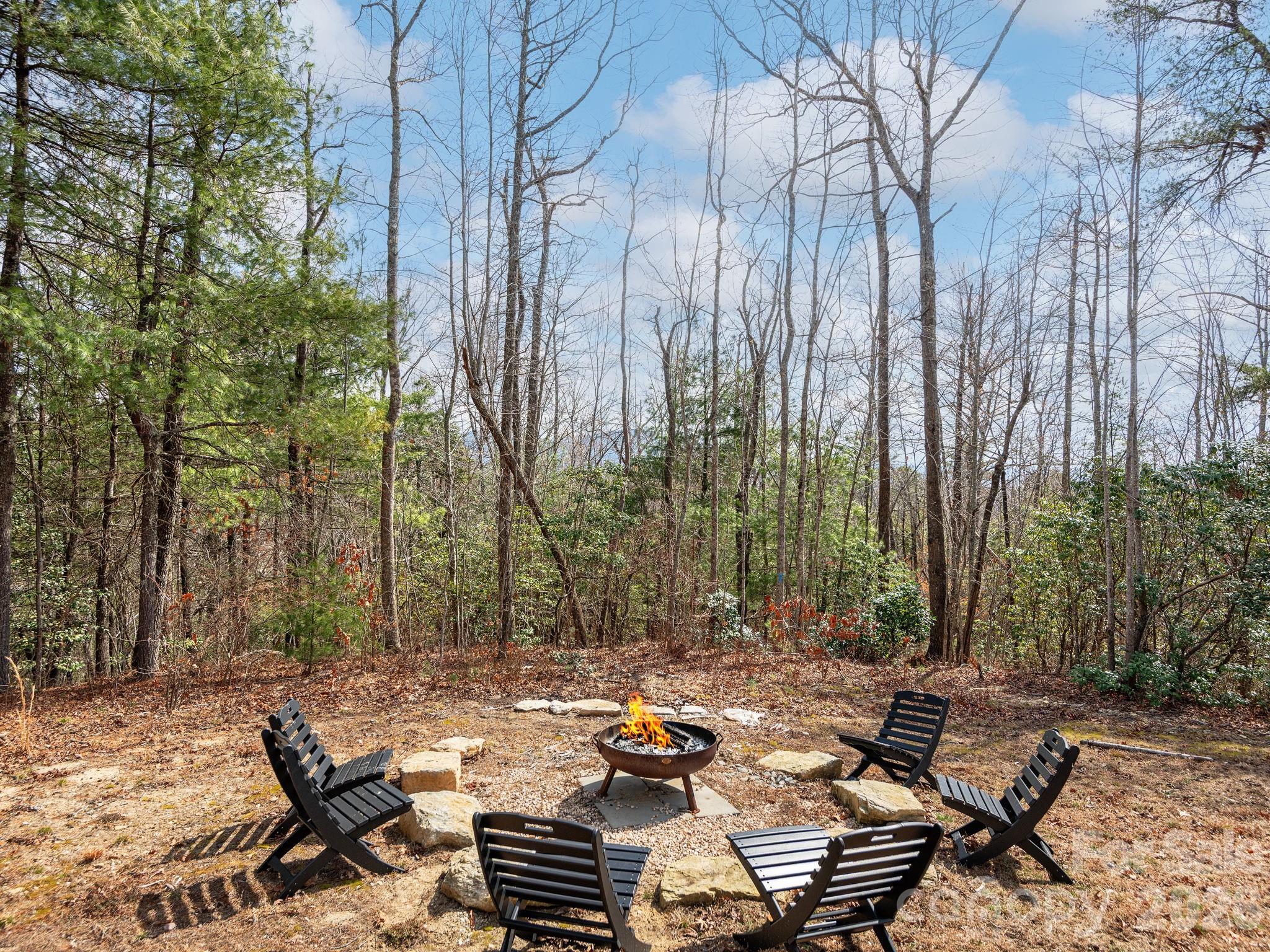 2201 Bulling Creek Road Hendersonville, NC 28739 - Photo 30 of 47 a view of a patio with table and chairs and wooden fence