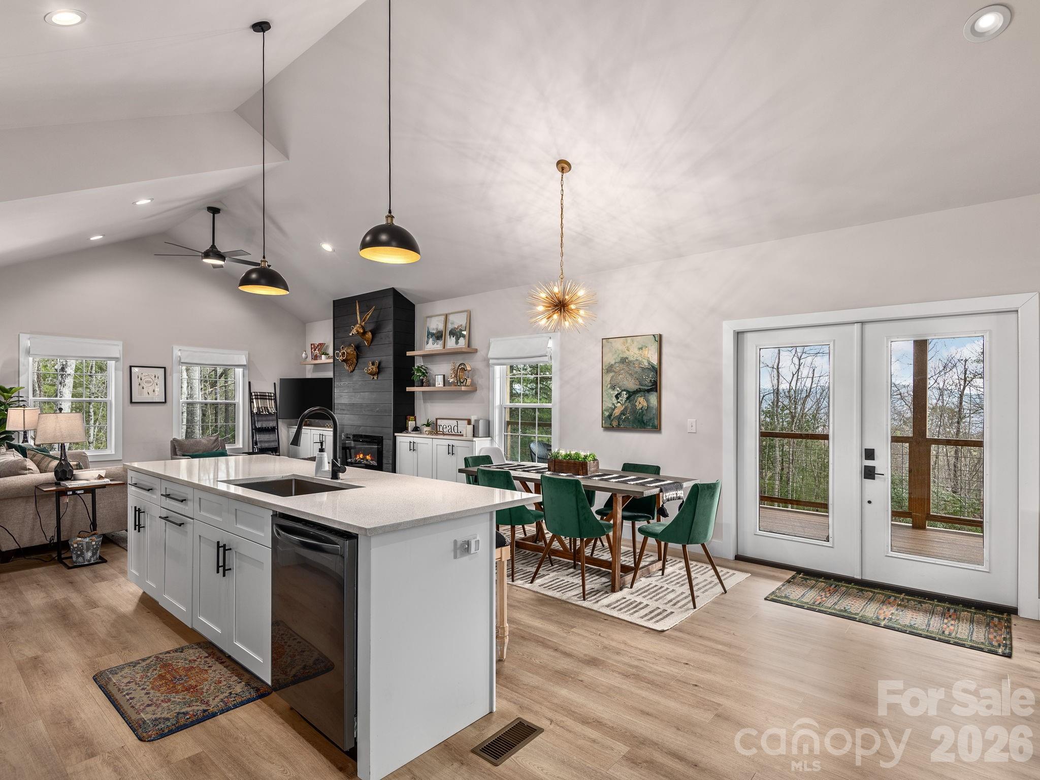 2201 Bulling Creek Road Hendersonville, NC 28739 - Photo 6 of 47 a open kitchen with stainless steel appliances granite countertop a stove and chairs with wooden floor