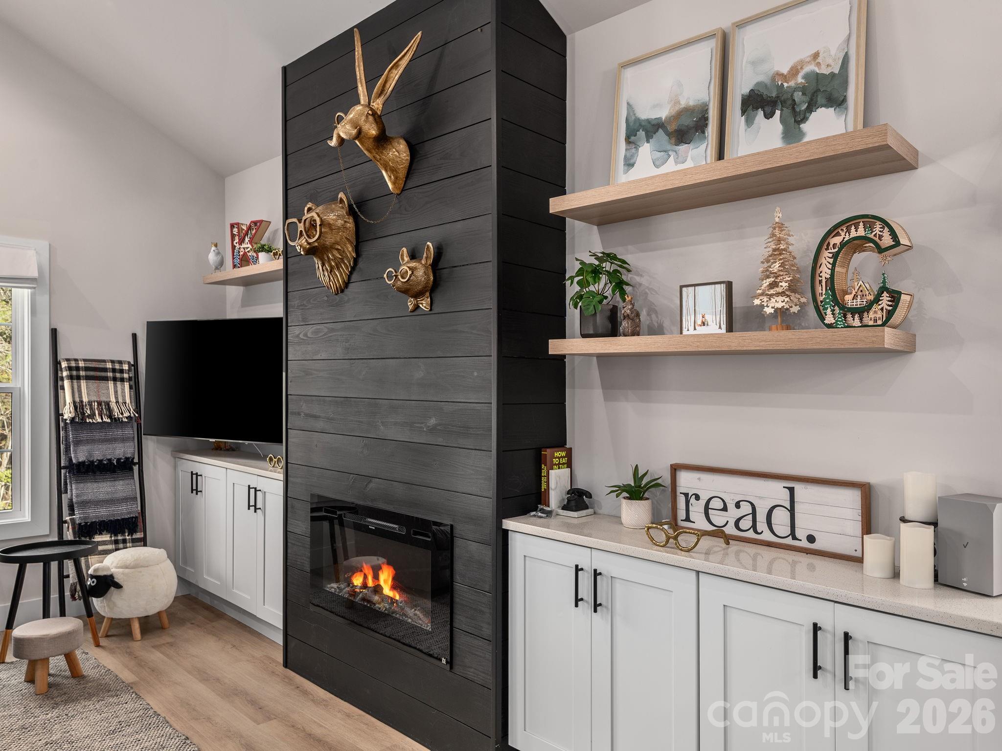 2201 Bulling Creek Road Hendersonville, NC 28739 - Photo 8 of 47 a living room with furniture and a fireplace