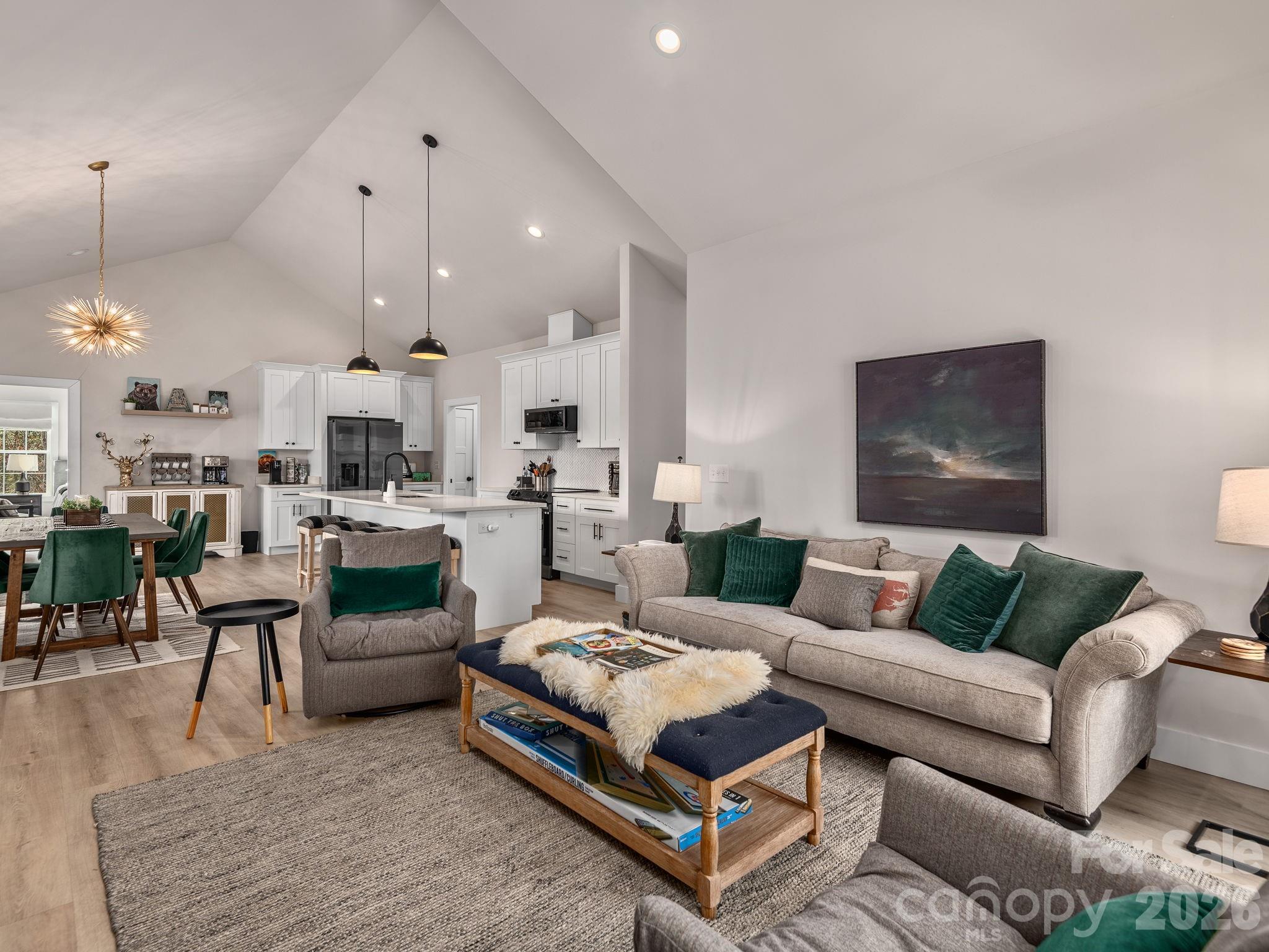 2201 Bulling Creek Road Hendersonville, NC 28739 - Photo 9 of 47 a living room with furniture kitchen view and a chandelier