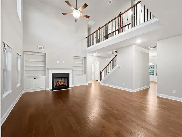 a large kitchen with stainless steel appliances and white cabinets