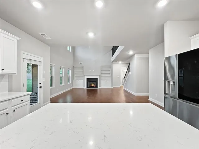 an empty room with windows and closet