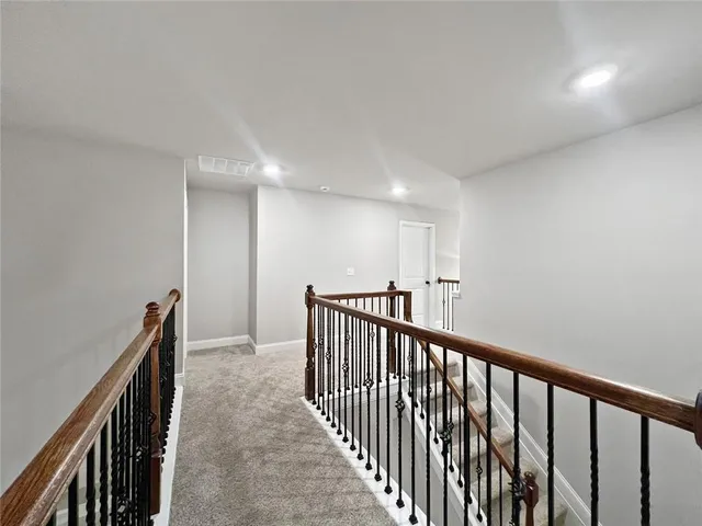 an empty room with ceiling fan and window