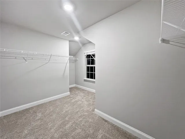a spacious bathroom with a double vanity sink a mirror and a bathtub