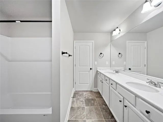 a bathroom with a sink mirror bathtub and toilet