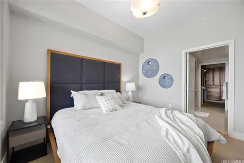a bedroom with a bed and a lamp