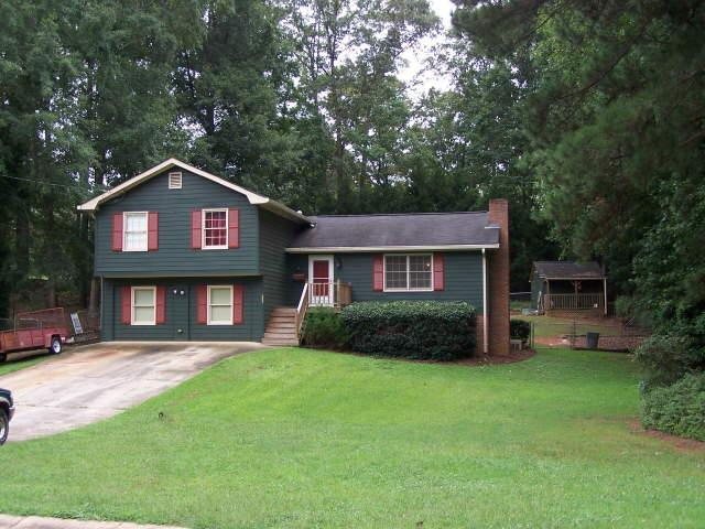 683 Deering Road Southeast Conyers, GA 30094 - Photo 1 of 1 a front view of a house with a garden and yard