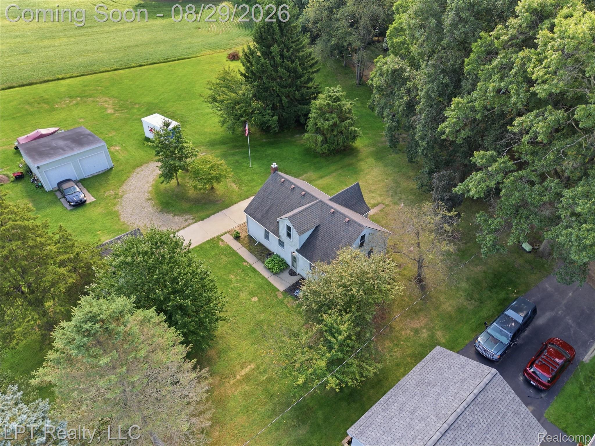 Gabled roofline residence with a detached two-car garage
