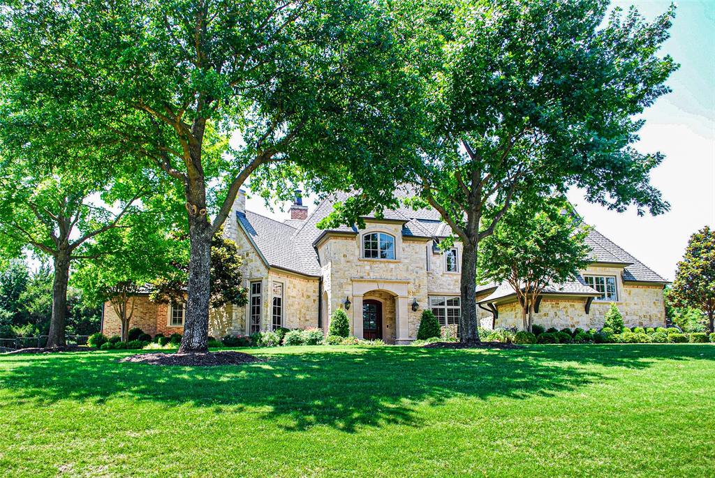 907 Foxglove Trail Fairview, TX 75069 - Photo 1 of 37 a front view of a house with a garden and trees