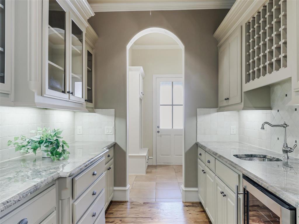 907 Foxglove Trail Fairview, TX 75069 - Photo 12 of 37 a kitchen with granite countertop white cabinets and white appliances