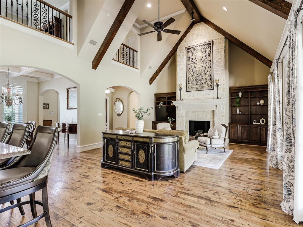 907 Foxglove Trail Fairview, TX 75069 - Photo 14 of 37 a living room with furniture a fireplace and a flat screen tv