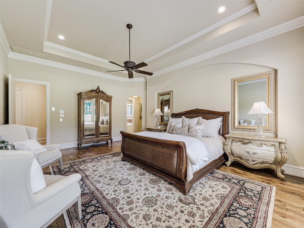 907 Foxglove Trail Fairview, TX 75069 - Photo 18 of 37 a spacious bedroom with a bed a couch and dresser