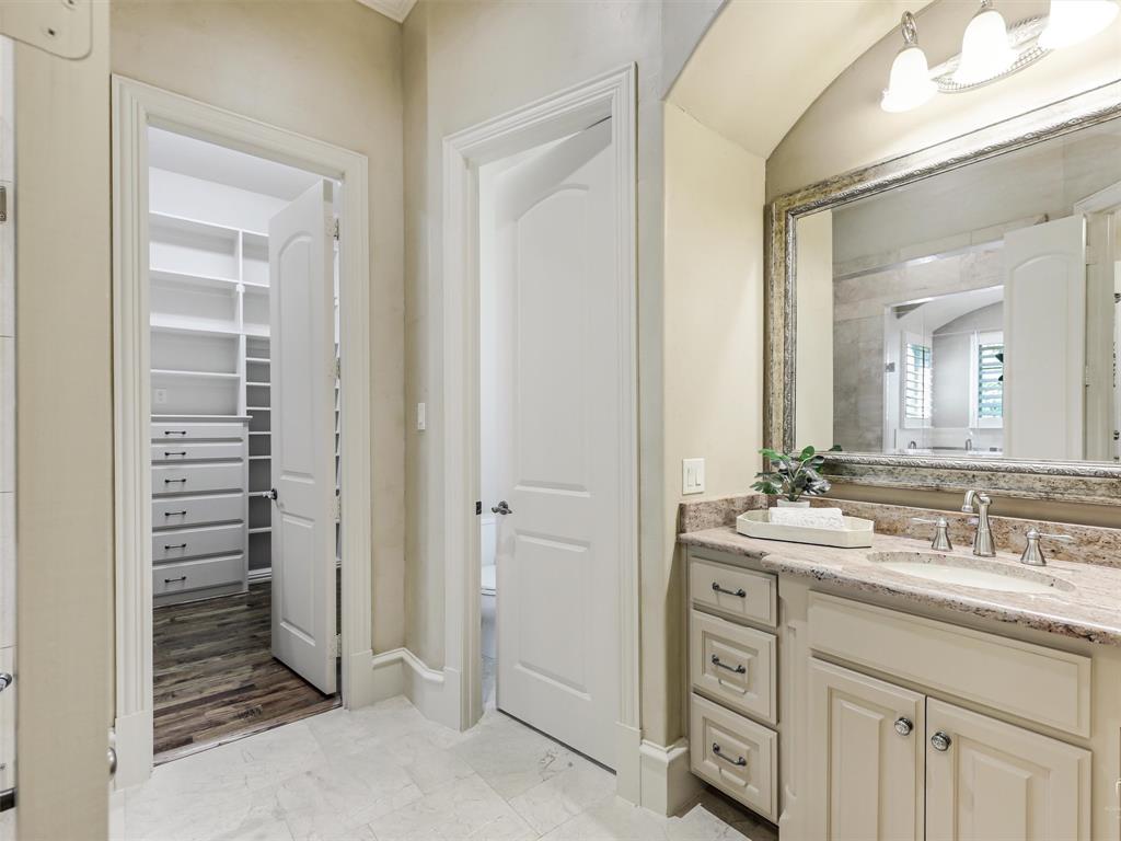 907 Foxglove Trail Fairview, TX 75069 - Photo 20 of 37 a bathroom with a granite countertop sink and a mirror
