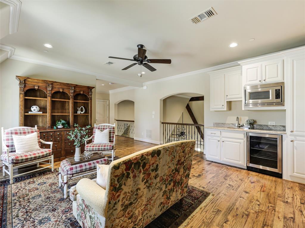 907 Foxglove Trail Fairview, TX 75069 - Photo 24 of 37 a living room with stainless steel appliances furniture a rug and a kitchen view