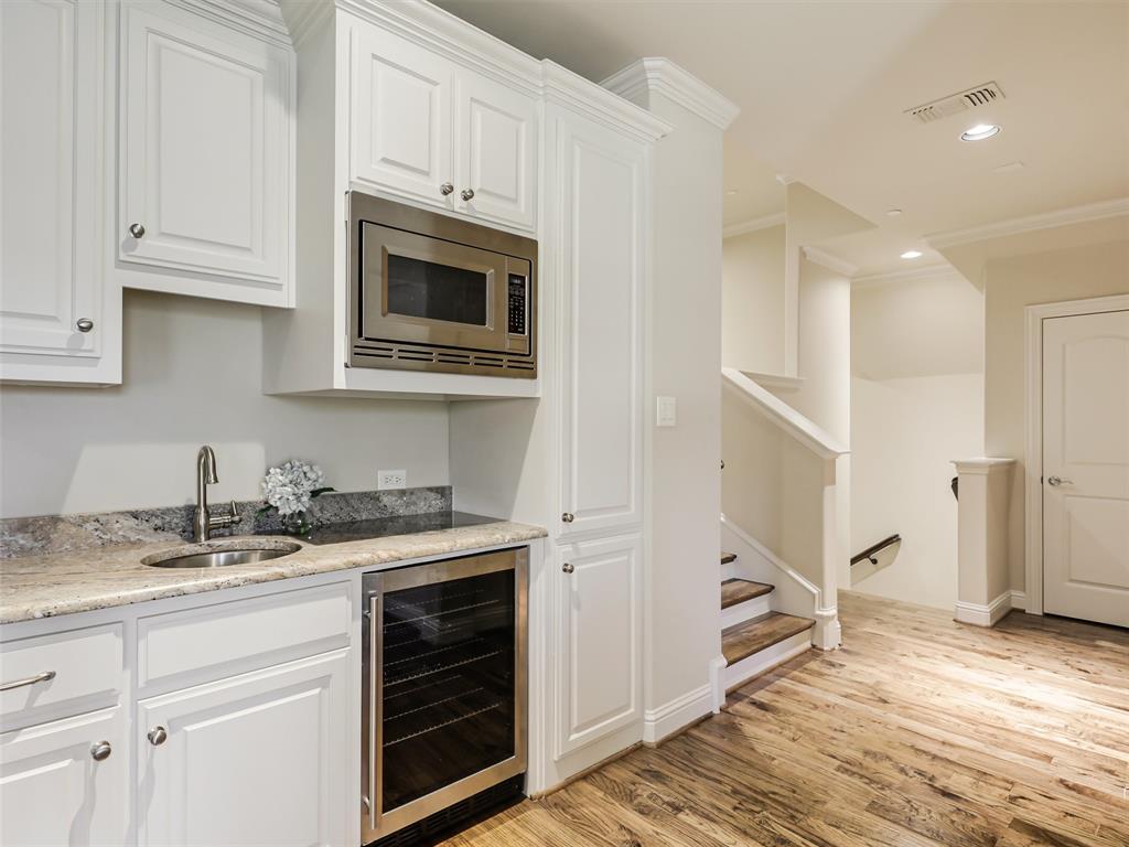 907 Foxglove Trail Fairview, TX 75069 - Photo 27 of 37 a kitchen with granite countertop white cabinets and white appliances