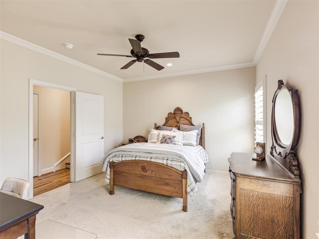 907 Foxglove Trail Fairview, TX 75069 - Photo 29 of 37 a bedroom with a bed a dresser and potted plants
