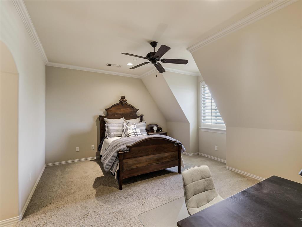 907 Foxglove Trail Fairview, TX 75069 - Photo 30 of 37 a bedroom with a bed and a chandelier