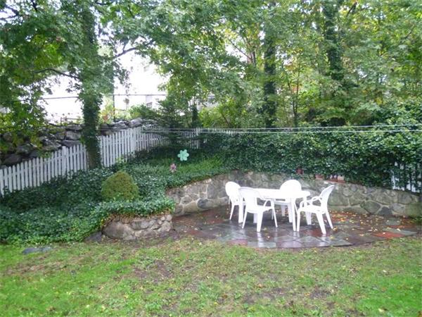54 Edmund Road Arlington, MA 02474 - Photo 11 of 12 a view of a table and chairs in the garden