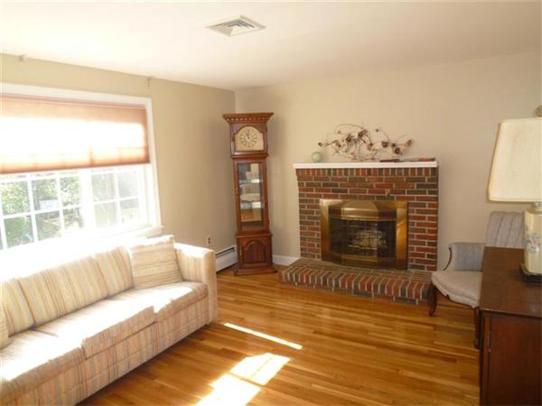 54 Edmund Road Arlington, MA 02474 - Photo 2 of 12 a living room with furniture a fireplace and a table