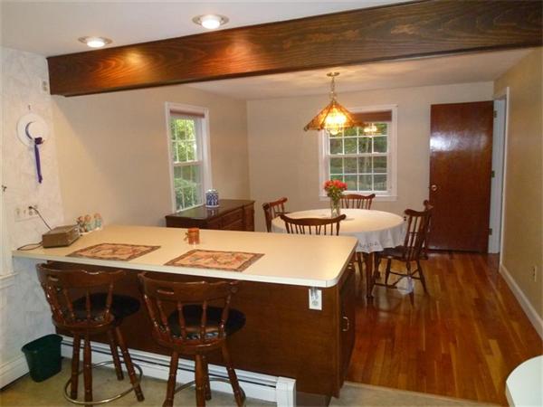 54 Edmund Road Arlington, MA 02474 - Photo 3 of 12 a dining room with a table chairs and a wooden floor