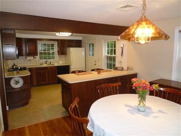 54 Edmund Road Arlington, MA 02474 - Photo 4 of 12 a kitchen with a table and chairs in it