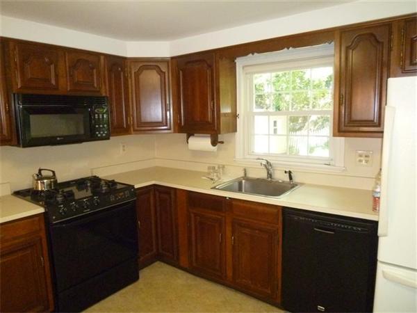 54 Edmund Road Arlington, MA 02474 - Photo 5 of 12 a kitchen with granite countertop a sink stove and cabinets