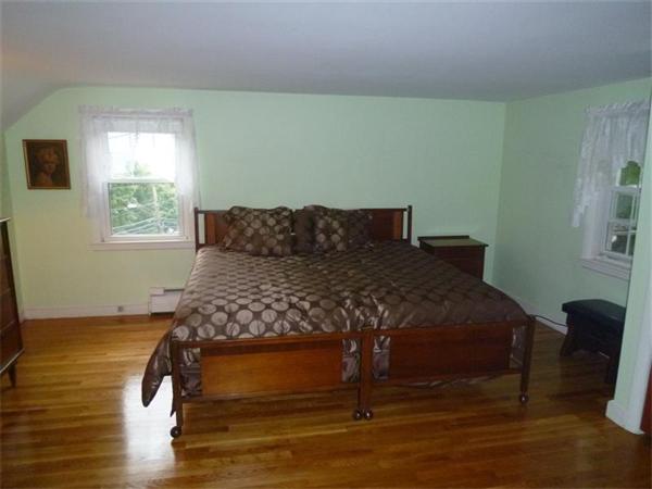 54 Edmund Road Arlington, MA 02474 - Photo 7 of 12 a bed sitting in a bedroom next to a window