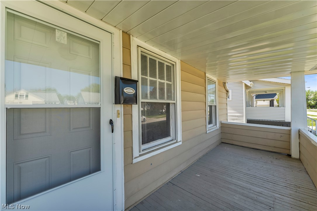 12808 Havana Road Cleveland, OH 44125 - Photo 3 of 19 Covered front porch featuring wood-finish flooring, white porch ceiling, and beige siding