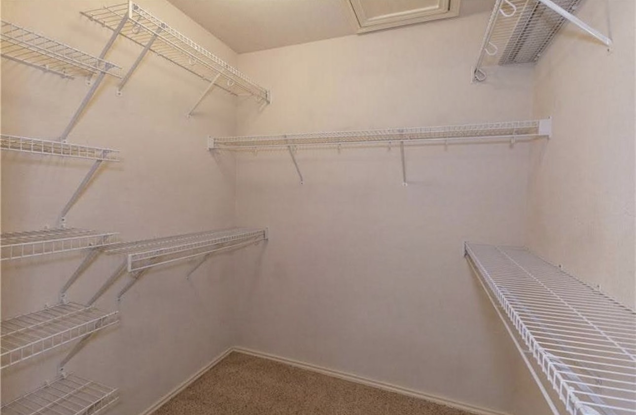 1900 Scofield Ridge Parkway, Unit 3101 Austin, TX 78727 - Photo 16 of 24 Walk-in closet with beige carpeting and multiple white wire shelving units